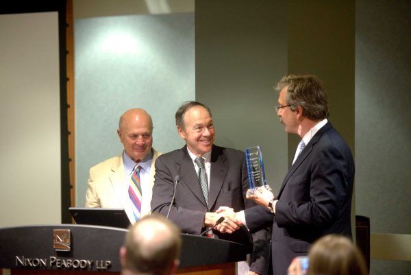 John Keith, President of Keith Construction and Michael Putziger, Chairman of WinnCompanies present Larry Curtis with the Lawyers Clearinghouse Leadership Award.