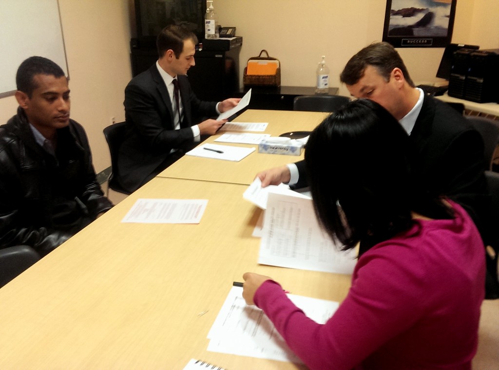 Volunteers meet with a client who needs help fighting an eviction.