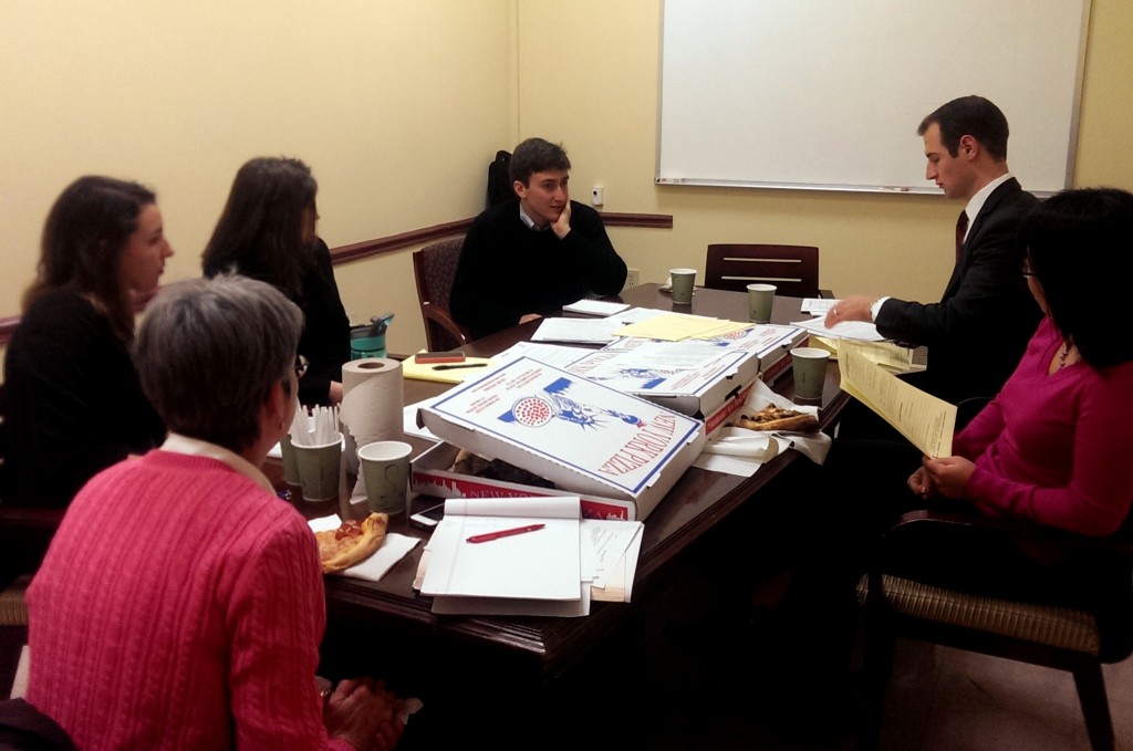 Volunteers discussing prospective cases during case review.